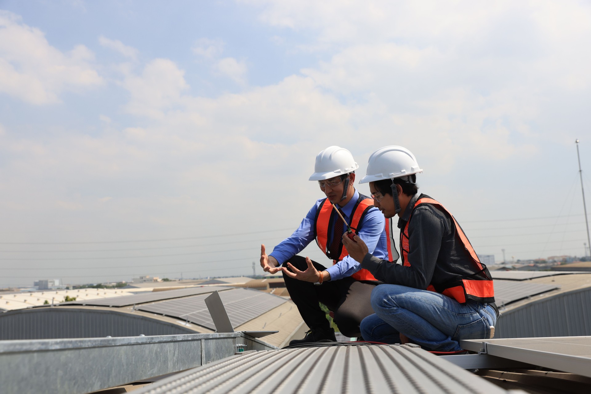 Businessman and solar engineer  examining photovoltaic panels